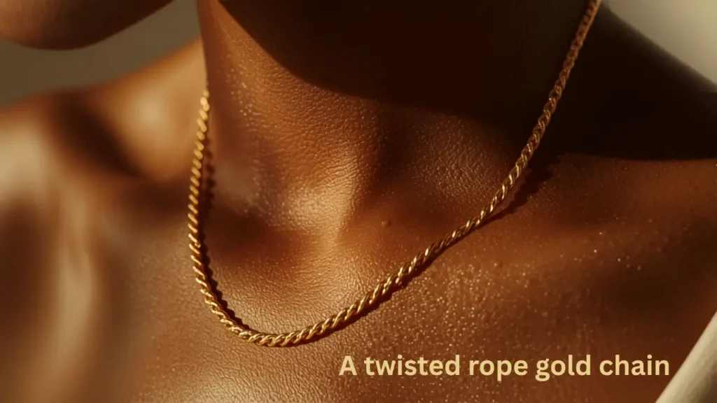 Twisted rope gold chain necklace resting on a woman's collarbone
