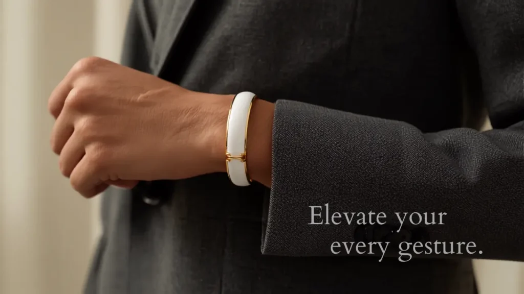 White enamel and gold cuff bracelet paired with a tailored blazer